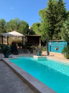 a swimming pool with blue water in a yard at Casa Lisboa in Cala Mesquida