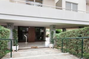an entrance to a building with plants in front of it at Spacious & Airy 1BR Apartment near HELEXPO Marousi by UPSTREET in Athens