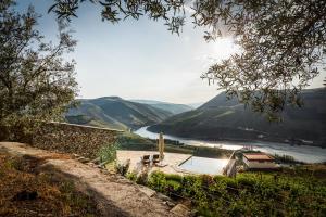 a view of a river with mountains in the background at Vineyard and Views Exquisite Luxury Douro Villa with Sun-Drenched Infinity Pool in Folgosa