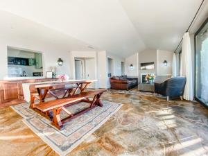 a living room with a wooden table and a couch at Vineyard and Views Exquisite Luxury Douro Villa with Sun-Drenched Infinity Pool in Folgosa