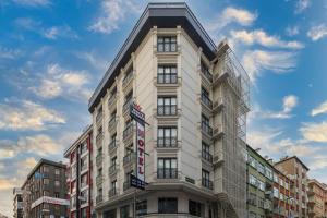 a tall white building with a sign on it at White Corner Hotel in Istanbul
