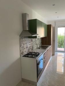 a kitchen with a stove top oven next to a window at Suite in Città residence in Isernia