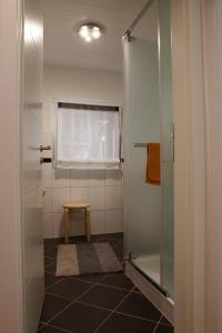 a bathroom with a shower and a stool in it at Panorama-Rheinblick St. Goar in Sankt Goar
