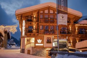 a wooden building with a sign in front of it at Schindler in Sankt Anton am Arlberg