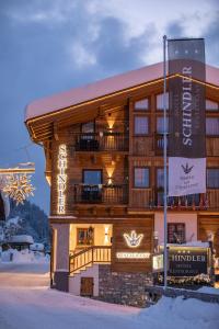a large wooden building with a sign in front of it at Schindler in Sankt Anton am Arlberg