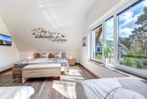 a bedroom with two beds and a window at Seeperle in Ostseebad Karlshagen