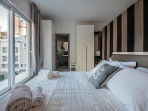 a bedroom with a large bed with a large window at COZY studio-flat in PACEVILLE in St. Julianʼs