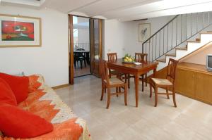 a living room with a table and a dining room at Amalfi 51 con vista mare, giardino e terrazze in Conca dei Marini
