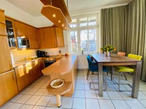 a kitchen with a wooden table and a dining room at Villa Caprivi - Ferienwohnung 6 in Neuhof