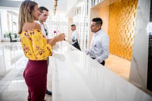 a group of people standing around a counter at Majestic Elegance Costa Mujeres - All Inclusive in Cancún