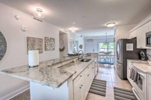 a large kitchen with a large marble counter top at Dazzling Mexico Beach Condo - Walk to the Beach! in Mexico Beach