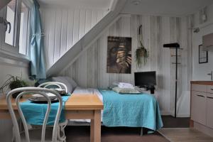 a bedroom with a bed and a table with chairs at Bed & Breakfast Hotel Zandvoort in Zandvoort