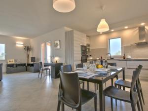 a dining room and kitchen with a table and chairs at Holiday Home La Rocchetta by Interhome in Montescudaio