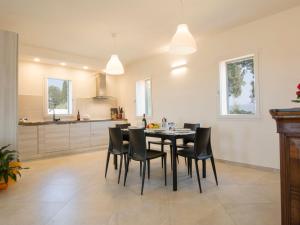 a kitchen and dining room with a table and chairs at Holiday Home La Rocchetta by Interhome in Montescudaio +20 photos