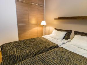 a bedroom with a bed and a closet at Holiday Home Ylläs chalets 2101 by Interhome in Ylläsjärvi +8 photos