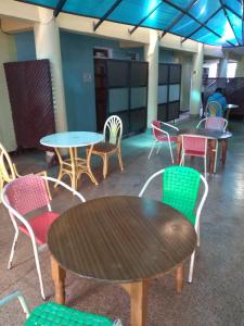 un grupo de mesas y sillas en una habitación en Crown Hotel Kericho, en Kericho