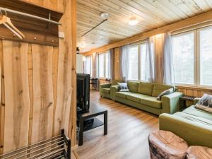 a living room with a couch and a tv at Holiday Home Koivu by Interhome in Sonkajärvi