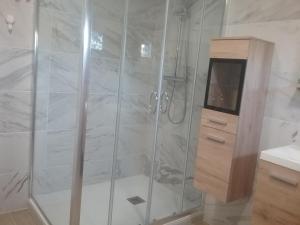 a shower with a glass door in a bathroom at Chez claudine in Favières