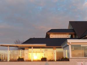 a house with a black roof at Strand-Hotel in Dangast