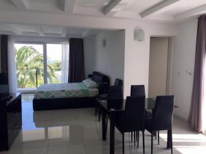 a bedroom with a table and chairs and a bed at Villa Cube in Premantura