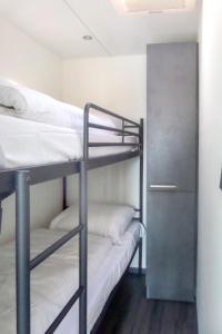a bunk room with two bunk beds and a locker at Holiday Home De Meerparel-1 by Interhome in Uitgeest +17 photos