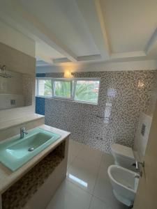 a bathroom with a sink and a toilet at Villa Cube in Premantura