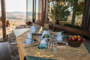 una mesa con un mantel con comida. en Masseria Xireni, en Castellana Sicula