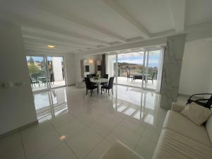 a living room with a couch and a table and chairs at Villa Cube in Premantura