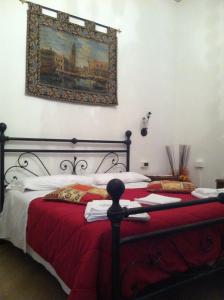 a bedroom with two beds and a painting on the wall at B&B Ca' Dor in Venice