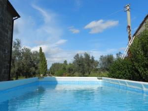 a swimming pool in a house with a blue sky at Agriturismo Le Sorgenti in Pitigliano