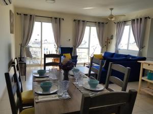 a living room with a table with chairs and a couch at Penthouse Apartment Universal in Paphos City