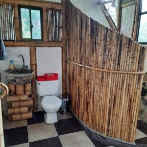 a bathroom with a toilet and a sink at Colibamboo Ecolodge Biocasa artesanal rodeada de naturaleza con jaccuzi y mucho más in Pacho