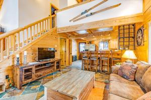 a living room with a couch and a table and a kitchen at Keechelus Lodge in Snoqualmie Pass