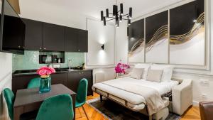 a bedroom with a bed and a table and chairs at Luxury 2 bedroom 2 bathroom - Louvre & Marais in Paris