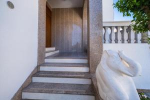 a statue of a woman standing next to a staircase at Villa Mirjana in Trogir