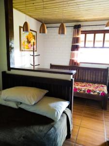 A bed or beds in a room at Hotel Praia Do Rosa