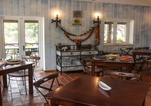 a dining room with wooden tables and chairs at Belver Porto Dona Maria Resort in Luz