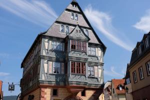 a tall building with a pointed roof at Zum Weissen Lamm in Rothenberg