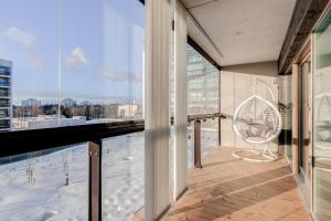 a balcony with a view of a city at Tapiola Oak Apartment in Espoo