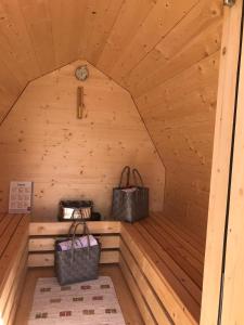 a sauna with two bags in a wooden cabin at Agriturismo Tolpei in La Valle