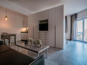 a living room with a couch and a table at COZY studio-flat in PACEVILLE in St. Julianʼs