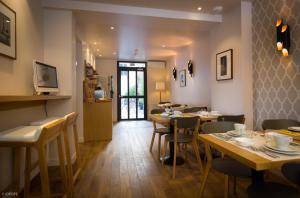 a dining room with wooden tables and chairs at Hotel Mirabeau Eiffel in Paris