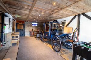 a room with a horse drawn carriage on display at Landhaus Flasch in Wagrain