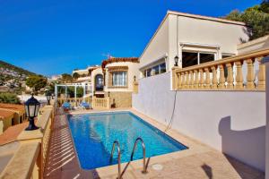 a villa with a swimming pool and a house at Tosal Julia - sea view villa with private pool in Calpe in Calpe