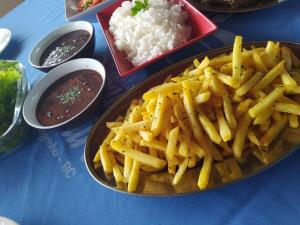 a plate of french fries and rice on a table at Recanto Paraíso Aventuras in Rio Negrinho