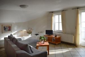 a living room with a couch and a table at Landhaus Gräfendhron in Gräfendhron