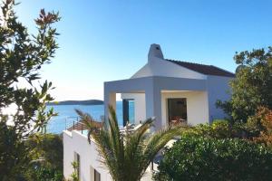 a white house with a view of the water at 180° Sea View Private House Vis Island archipelago in Podstražje
