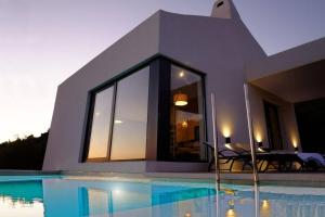 a house with a swimming pool in front of a house at 180° Sea View Private House Vis Island archipelago in Podstražje
