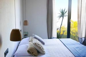 a bedroom with a bed with pillows and a window at 180° Sea View Private House Vis Island archipelago in Podstražje +48 photos