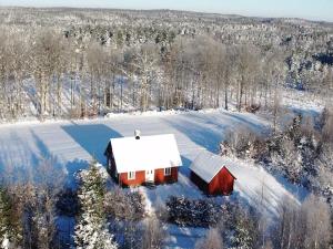 an aerial view of a red barn in the snow at Slättsjö in Slättsjö
